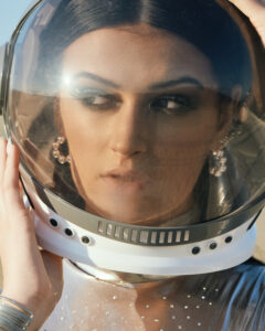 Photo of model in spacesuit with desert backgorund.