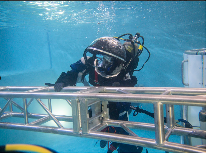 Photo of Dr. Pandya doing a simulated spacewalk underwater.